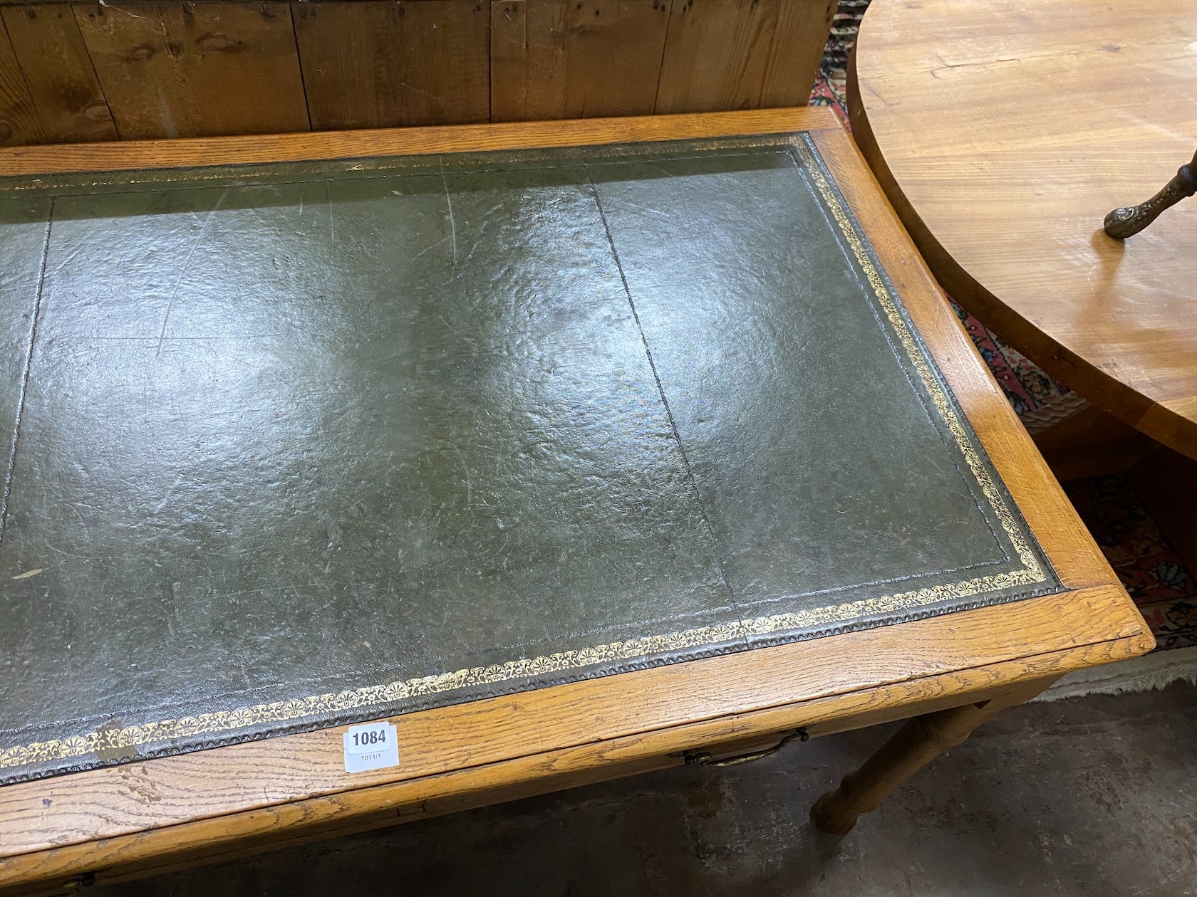 An early 20th century oak writing table, width 137cm